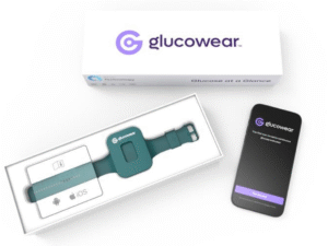 “Glucowear™ device shown in a teal-coloured watch-like device with no watch face. It sits in a white packaging box inside the charger complete with instructions. The lid of the box is displayed above which is white with the “Glucowear™ logo on it. It has a smartphone nearby showing the "Glucowear" app home screen.