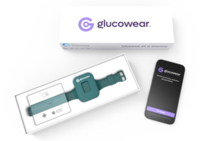 Glucowear product packaging on a white background, showing a teal wearable device inside an open box and a black device pouch with the Glucowear logo and text.