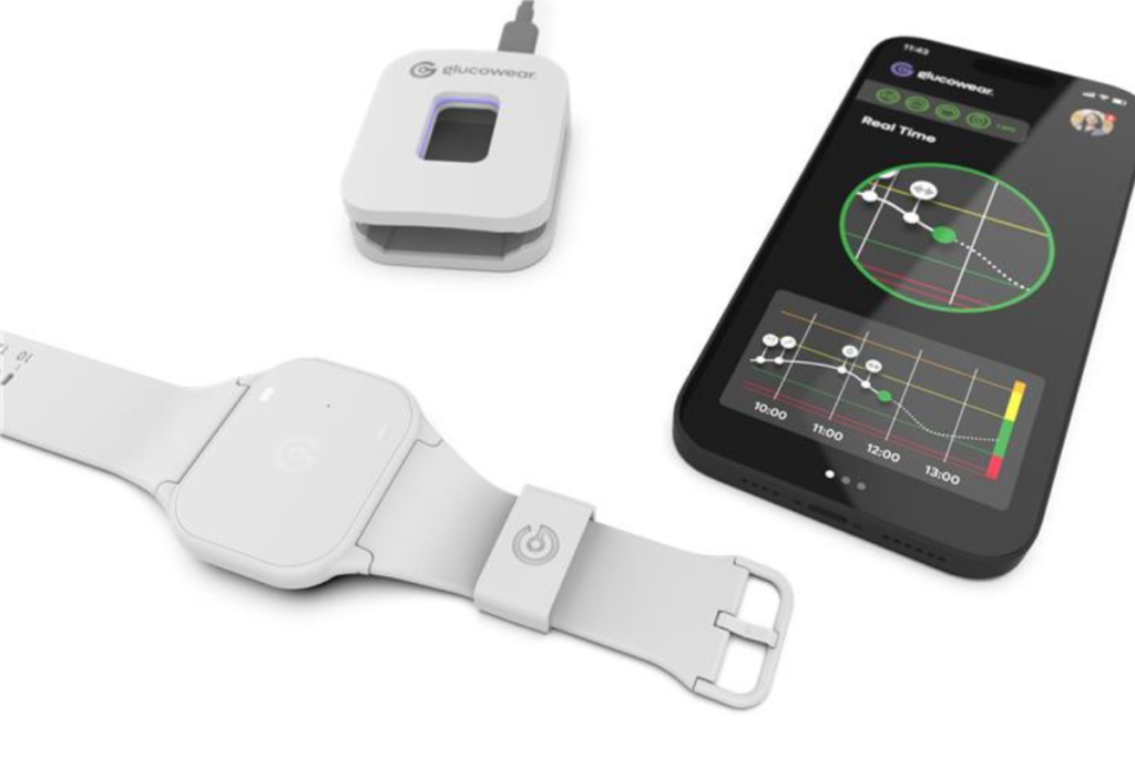 A Glucowear™ device setup showing a handheld monitor with a radar-style interface and a wearable sensor unit connected to a strap, displayed on a white background.